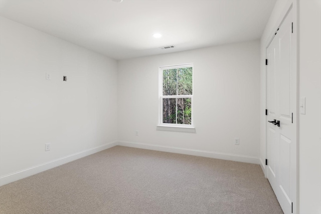 unfurnished bedroom featuring light carpet, a closet, baseboards, and visible vents