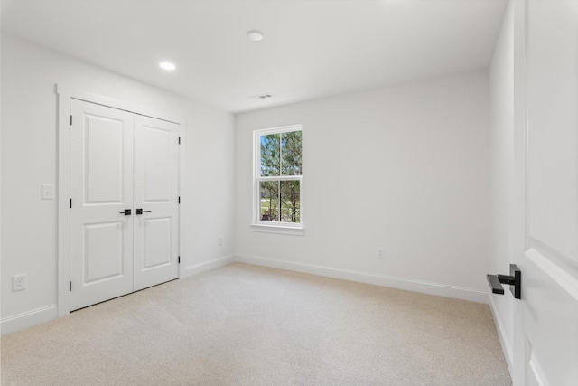 unfurnished bedroom with visible vents, baseboards, recessed lighting, and light carpet