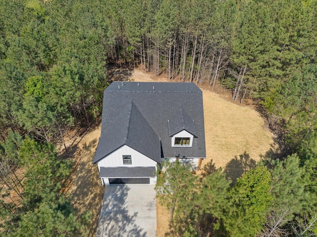 drone / aerial view featuring a forest view