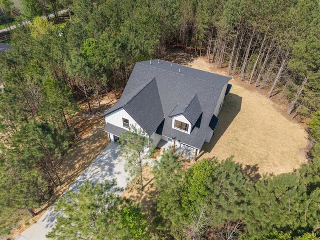 drone / aerial view featuring a forest view