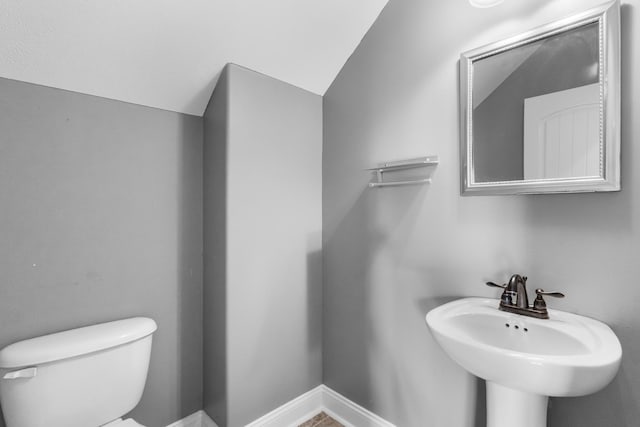 half bath with a sink and toilet