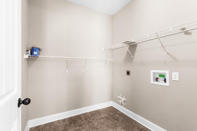 laundry area with electric dryer hookup, laundry area, baseboards, and washer hookup