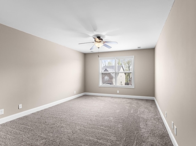 carpeted empty room with baseboards and ceiling fan