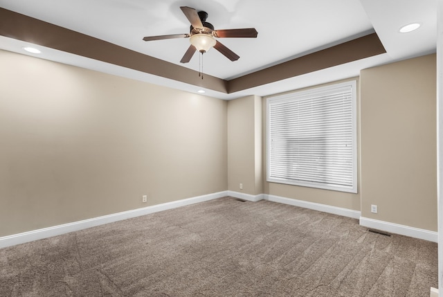 carpeted spare room featuring visible vents, ceiling fan, recessed lighting, and baseboards