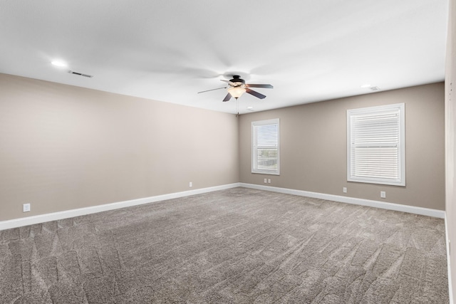 carpeted empty room featuring baseboards, a ceiling fan, visible vents, and recessed lighting