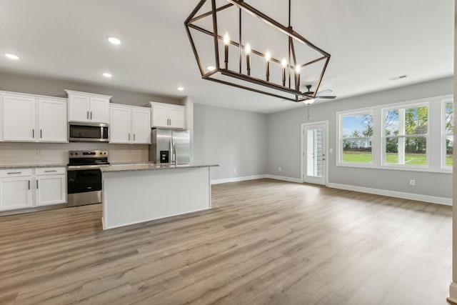 560 Twyla Dr, Lebanon, TN 37087 - kitchen with stainless steel appliances, decorative backsplash, recessed lighting, white cabinetry, and light wood-style floors