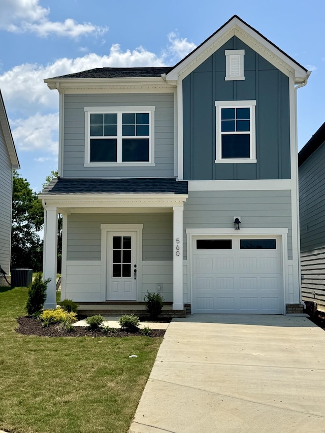560 Twyla Dr, Lebanon, TN 37087 - view of front of home featuring an attached garage, driveway, board and batten siding, a front yard, and a porch