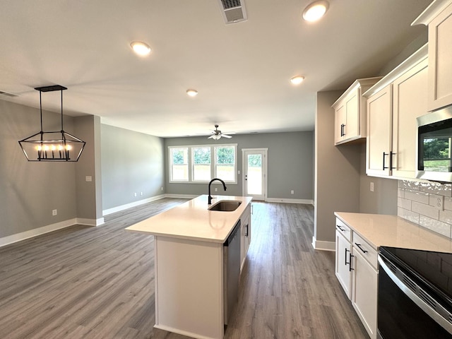 560 Twyla Dr, Lebanon, TN 37087 - kitchen with appliances with stainless steel finishes, open floor plan, wood finished floors, light countertops, and white cabinets