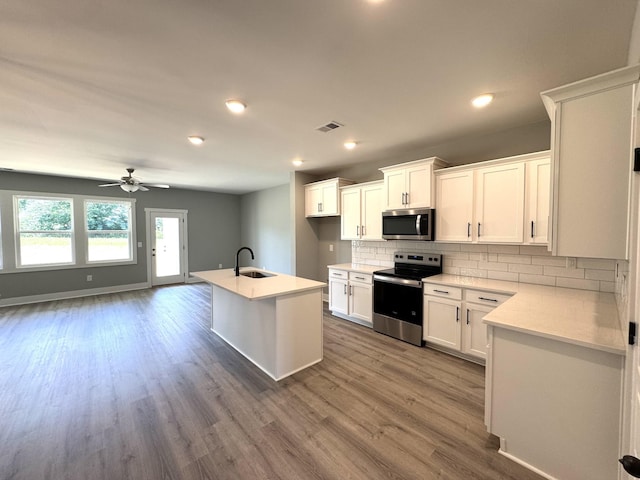 560 Twyla Dr, Lebanon, TN 37087 - kitchen featuring stainless steel appliances, backsplash, light countertops, dark wood-type flooring, and a ceiling fan