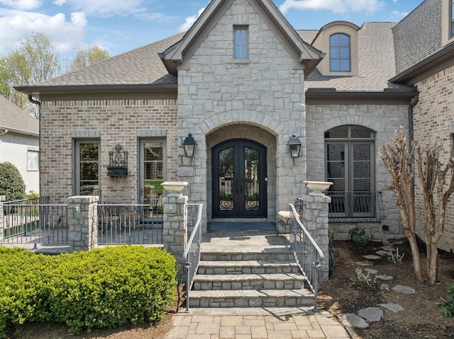 1499 Boardwalk Pl, Gallatin, TN 37066 - property entrance with french doors, stone siding, and roof with shingles