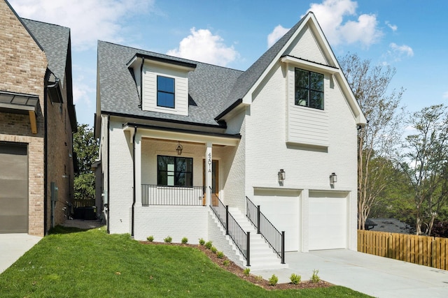 4201A Belmont Blvd, Nashville, TN 37215 - modern farmhouse style home featuring driveway, an attached garage, a porch, brick siding, and a shingled roof