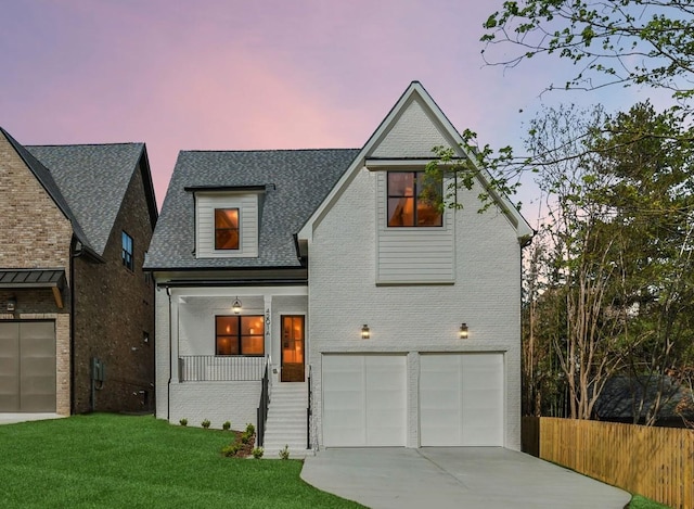 4201A Belmont Blvd, Nashville, TN 37215 - view of front of property with a garage, driveway, fence, a front yard, and brick siding