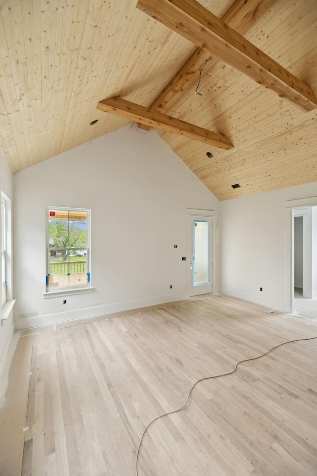 unfurnished living room with light wood-style flooring, baseboards, and a healthy amount of sunlight