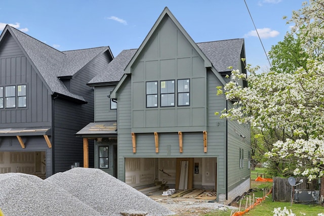 view of front of property with board and batten siding and a shingled roof
