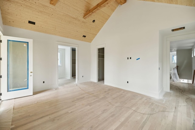interior space featuring high vaulted ceiling, light wood-style flooring, wood ceiling, baseboards, and beam ceiling
