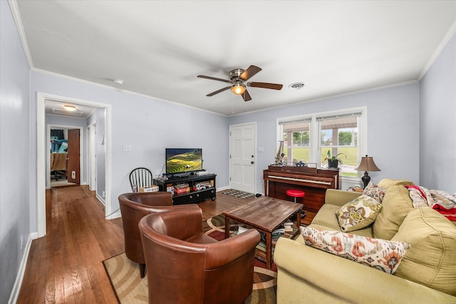 living room with ornamental molding, visible vents, ceiling fan, and wood-type flooring