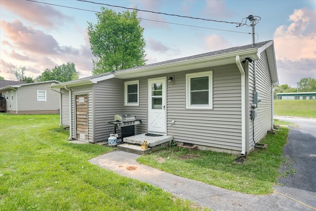back of property with a lawn