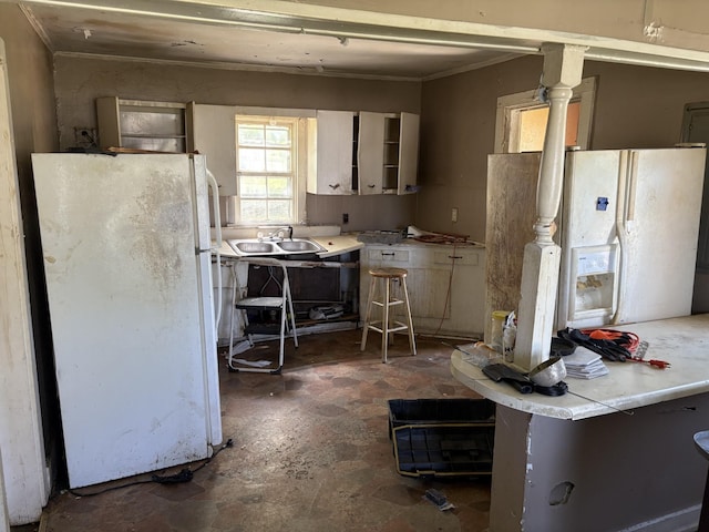 755 Center St, Lewisburg, TN 37091 - kitchen with crown molding, freestanding refrigerator, white fridge with ice dispenser, stone finish floor, and a sink