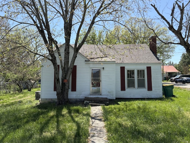 755 Center St, Lewisburg, TN 37091 - bungalow-style house featuring a front yard, a shingled roof, and a chimney