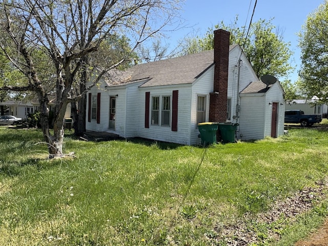 755 Center St, Lewisburg, TN 37091 - view of side of home with a yard, roof with shingles, and a chimney