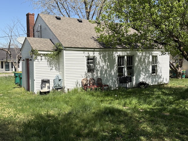 755 Center St, Lewisburg, TN 37091 - back of house with a yard, roof with shingles, and a chimney