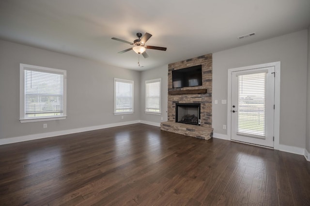 4302 Peacemill Ln, Murfreesboro, TN 37128 - unfurnished living room featuring a ceiling fan, a stone fireplace, plenty of natural light, and dark wood-type flooring