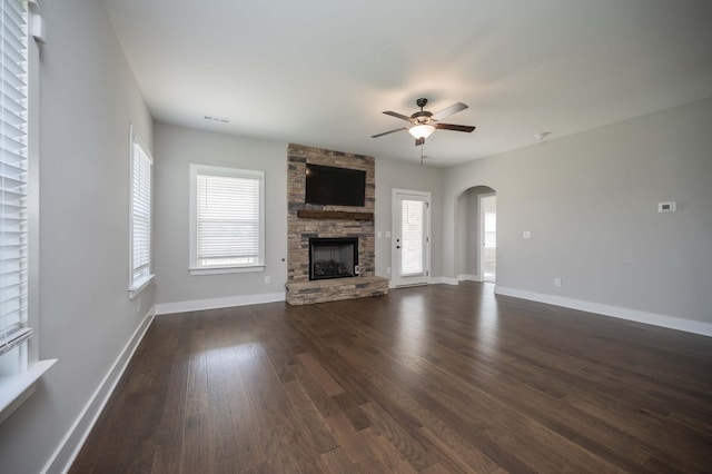 4302 Peacemill Ln, Murfreesboro, TN 37128 - unfurnished living room featuring a ceiling fan, arched walkways, dark wood finished floors, and a fireplace