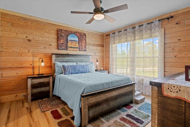 229 Blackhawk Ct, Waverly, TN 37185 - bedroom with hardwood / wood-style flooring, wood walls, and a ceiling fan