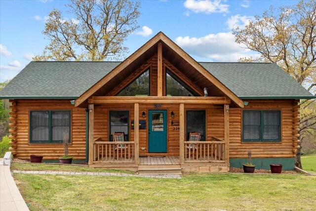 229 Blackhawk Ct, Waverly, TN 37185 - log home featuring log exterior, roof with shingles, a porch, and a front yard