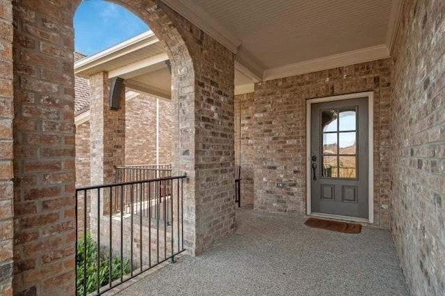 doorway to property with brick siding