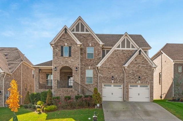 view of front of property featuring concrete driveway, a front yard, a garage, and brick siding