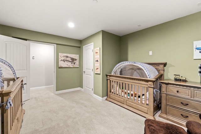bedroom featuring light carpet and baseboards