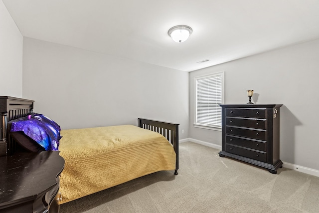 bedroom featuring visible vents, baseboards, and carpet