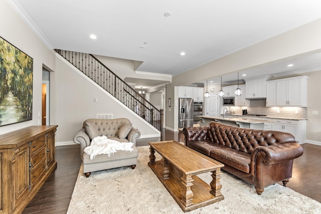 living area featuring stairs, dark wood-type flooring, visible vents, and crown molding