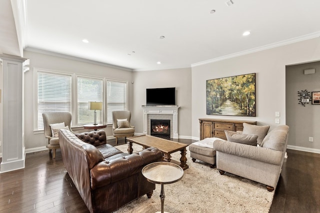 living area with a fireplace, dark wood-style flooring, baseboards, and ornamental molding