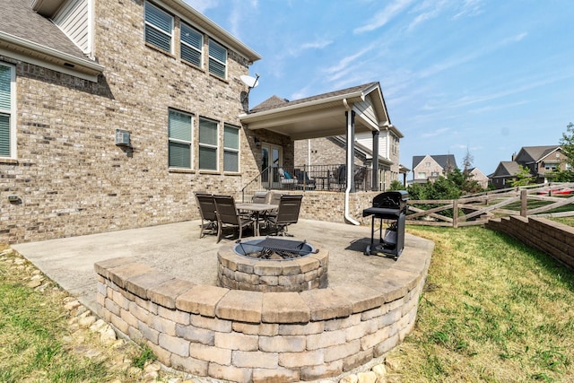 view of patio featuring fence, a fire pit, and a grill