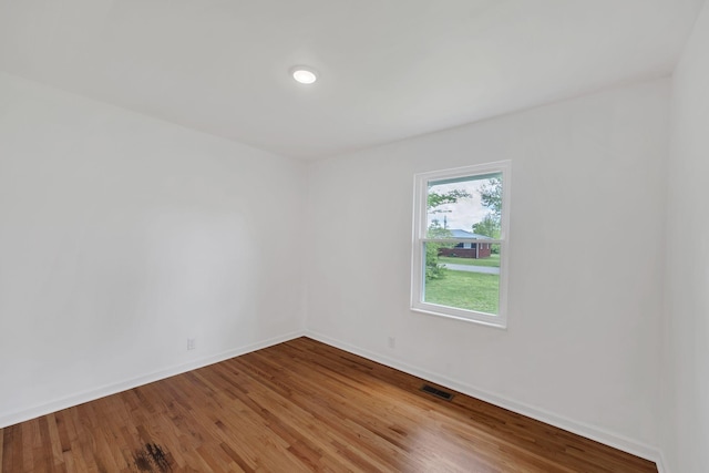 305 Thomas Ave, Hohenwald, TN 38462 - unfurnished room featuring visible vents, wood finished floors, and baseboards