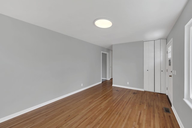 305 Thomas Ave, Hohenwald, TN 38462 - unfurnished bedroom featuring a closet, visible vents, baseboards, and light wood-style floors