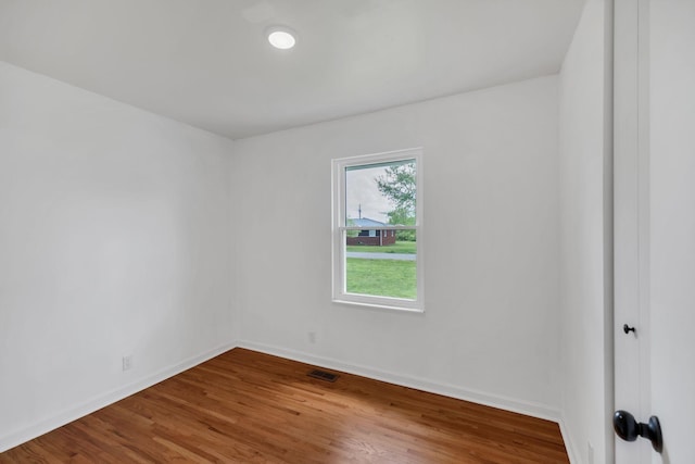 305 Thomas Ave, Hohenwald, TN 38462 - unfurnished room with baseboards, visible vents, and wood finished floors