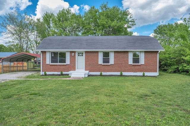 305 Thomas Ave, Hohenwald, TN 38462 - ranch-style house featuring brick siding, a detached carport, a front yard, and roof with shingles