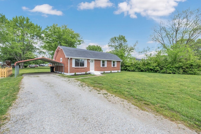 305 Thomas Ave, Hohenwald, TN 38462 - view of front facade with a front lawn, driveway, a detached carport, and brick siding