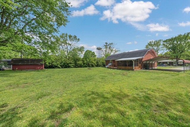 305 Thomas Ave, Hohenwald, TN 38462 - view of yard featuring a carport, a shed, and an outdoor structure