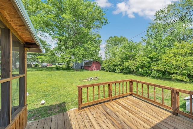 305 Thomas Ave, Hohenwald, TN 38462 - deck featuring a lawn, a storage unit, and an outbuilding