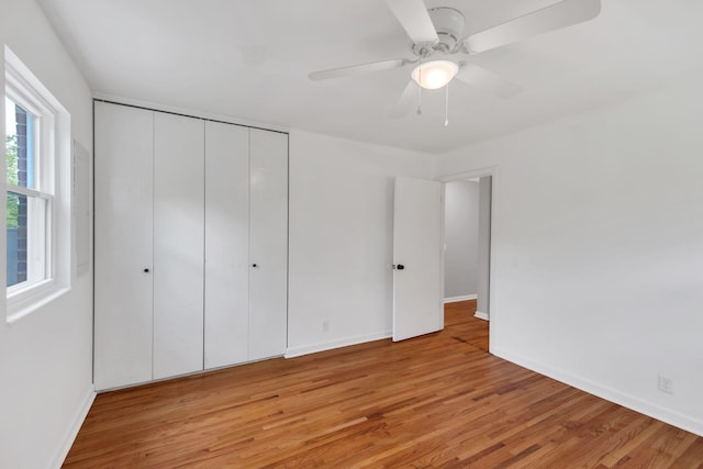 305 Thomas Ave, Hohenwald, TN 38462 - unfurnished bedroom featuring ceiling fan, baseboards, light wood-style flooring, and a closet