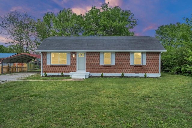 305 Thomas Ave, Hohenwald, TN 38462 - view of front facade featuring driveway, a yard, a detached carport, and brick siding