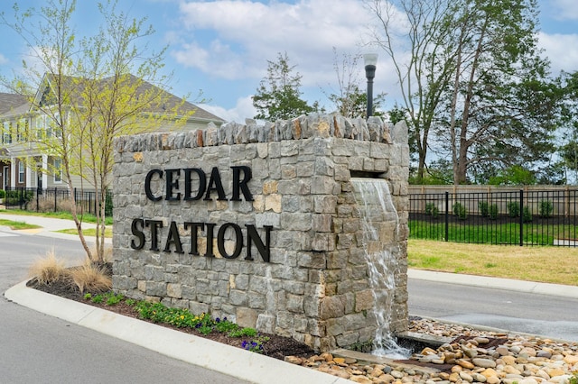 community sign featuring fence