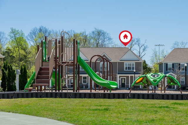 community jungle gym featuring a lawn