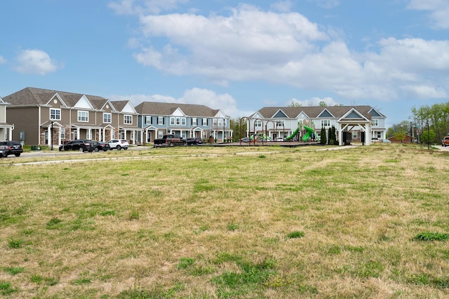 view of property's community featuring a yard and a residential view