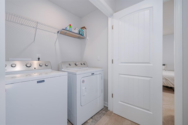 clothes washing area featuring independent washer and dryer and laundry area