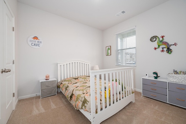 carpeted bedroom featuring visible vents and baseboards